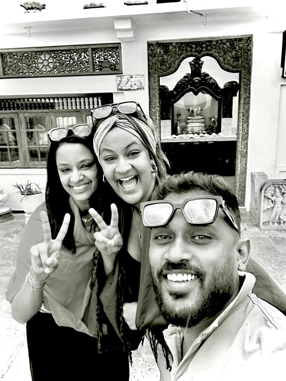 Happy tourists with tuk tuk driver at Buddhist temple entrance in Kandy