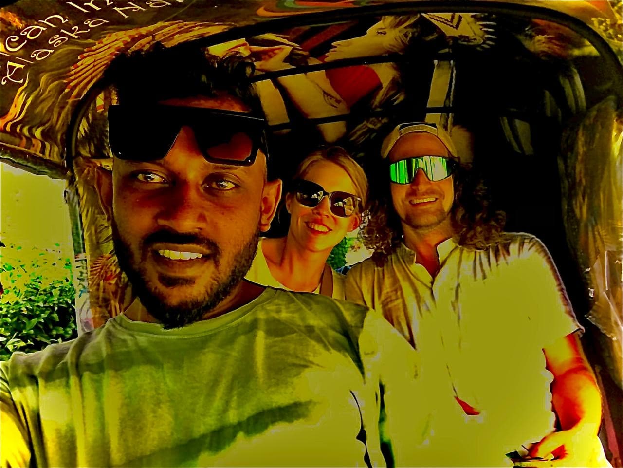 Happy tourists inside tuk tuk with driver Roshel - private tuk tuk tours Sri Lanka