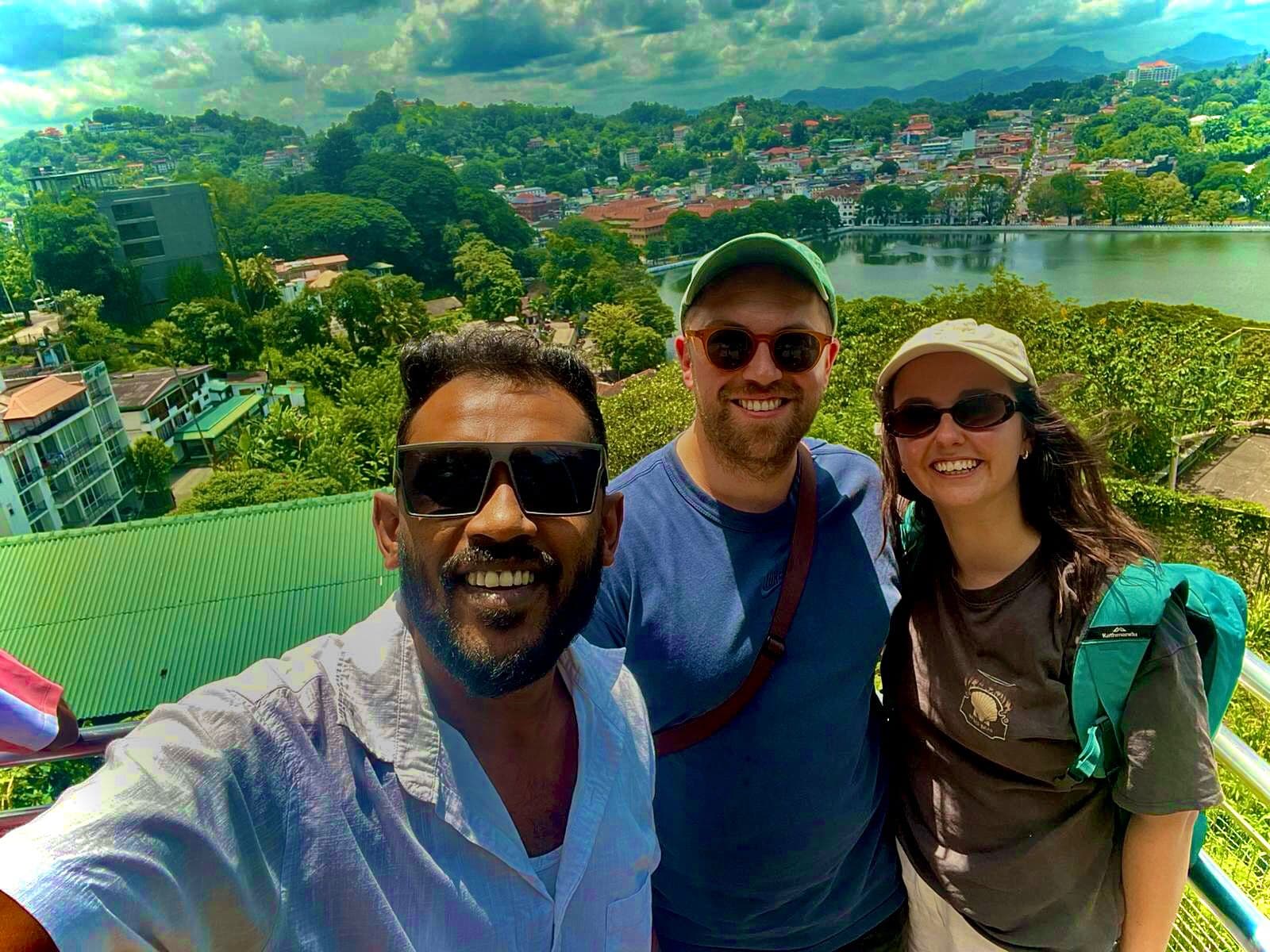 Tourists overlooking Kandy Lake panoramic view during tuk tuk city tour