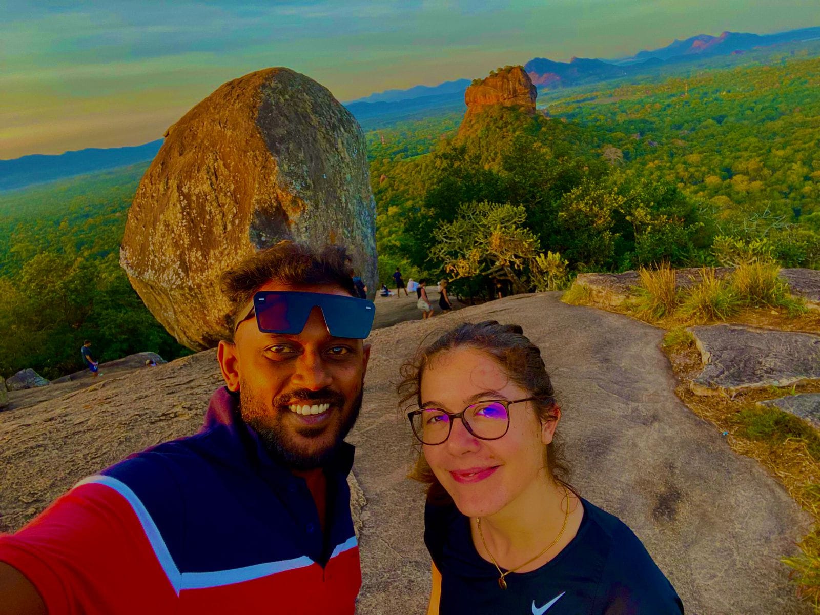 Tourists at Pidurangala Rock with Sigiriya Rock Fortress view during day trip from Kandy by tuk tuk