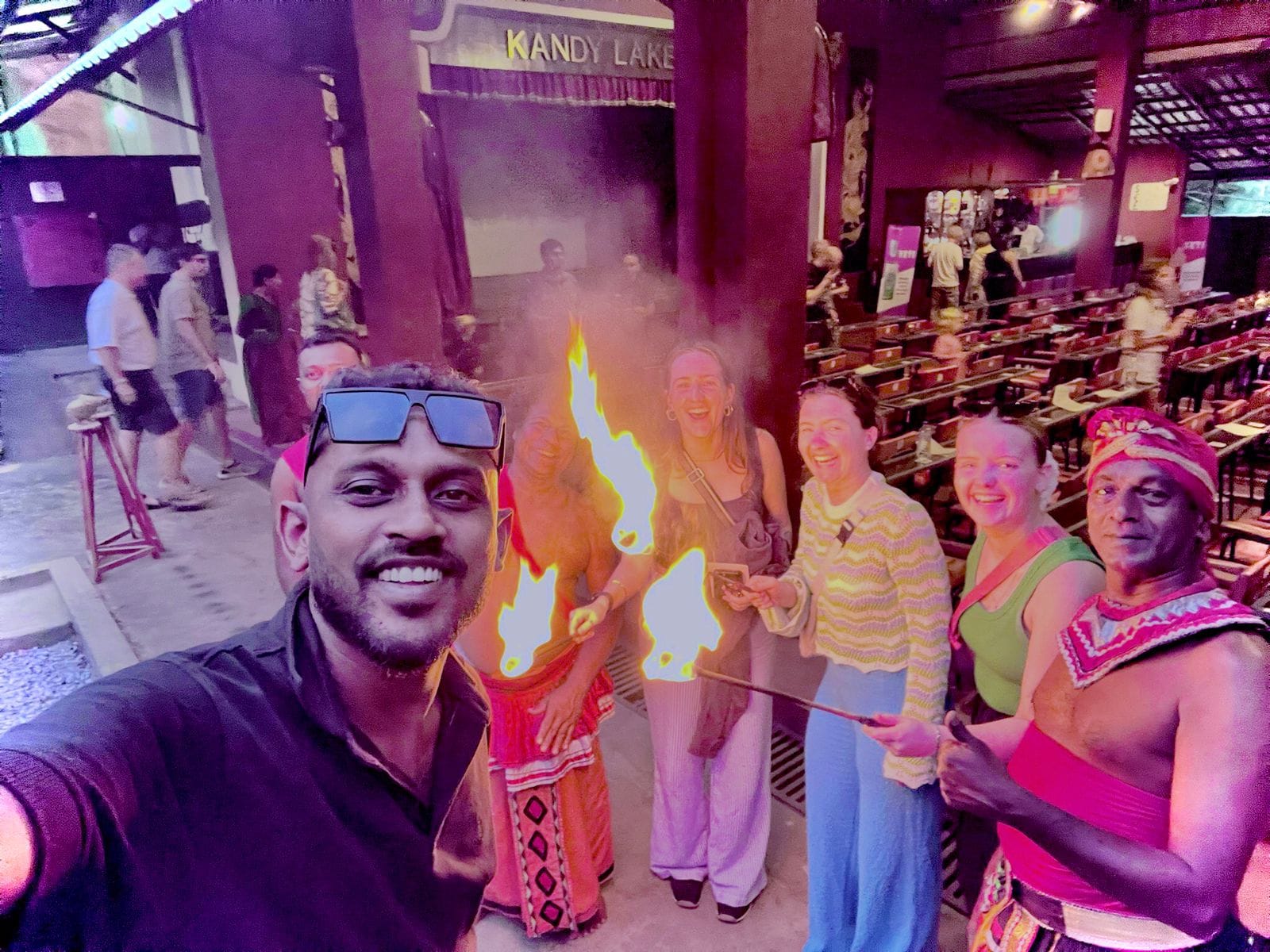 Tourists enjoying Kandyan fire dance show during a tuk tuk tour in Kandy Sri Lanka