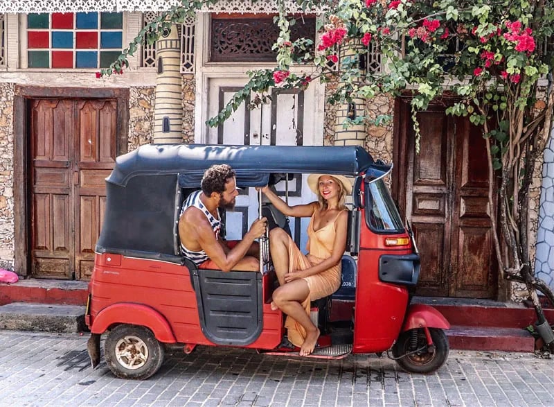 Couple enjoying a tuk tuk ride in Sri Lanka - authentic private tuk tuk tour experience through colorful streets